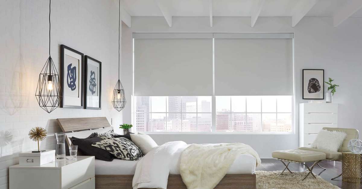 Sleek roller shades offering light filtering and privacy in a stylish bedroom, seamlessly integrating with the contemporary decor.